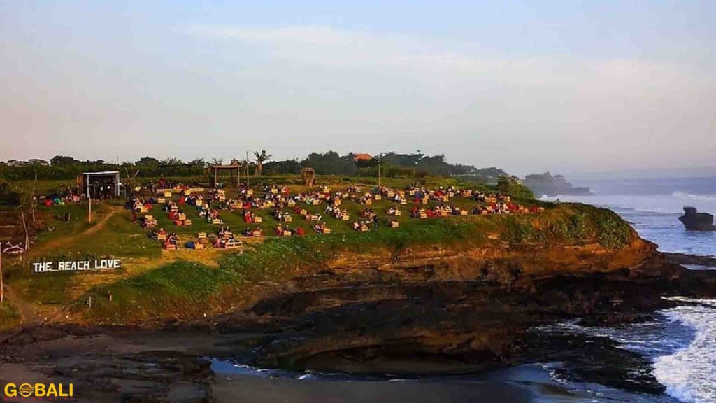 Suasana Pantai Kedungu di Tabanan Bali dengan ombak besar untuk surfing dan langit sunset yang indah.